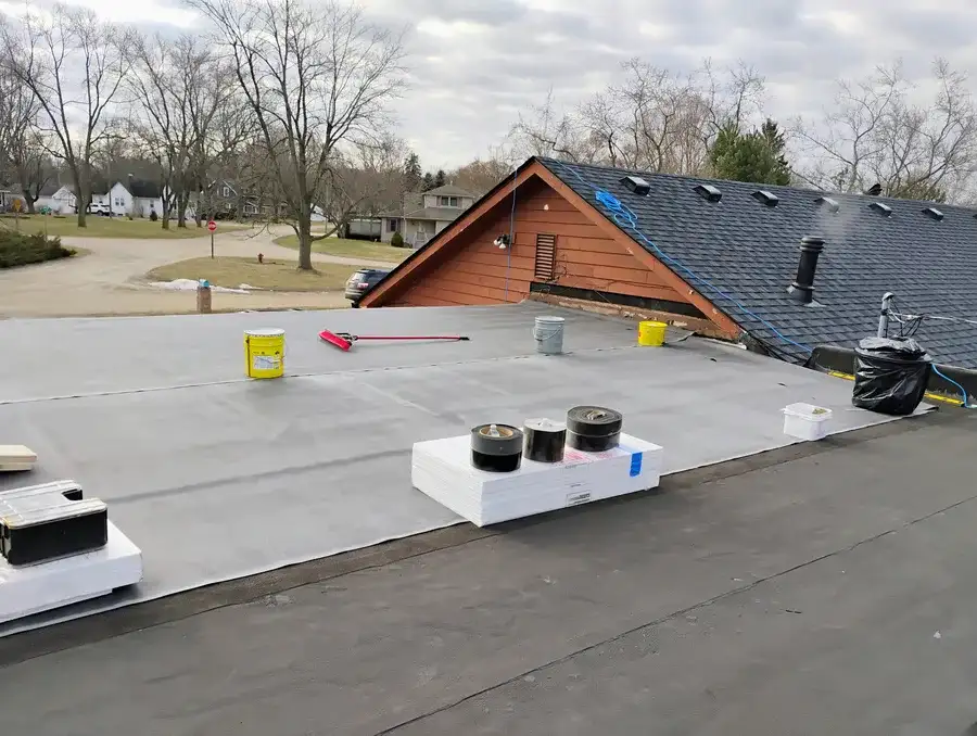 EPDM seam tape being applied on a flat roof in Metro Detroit