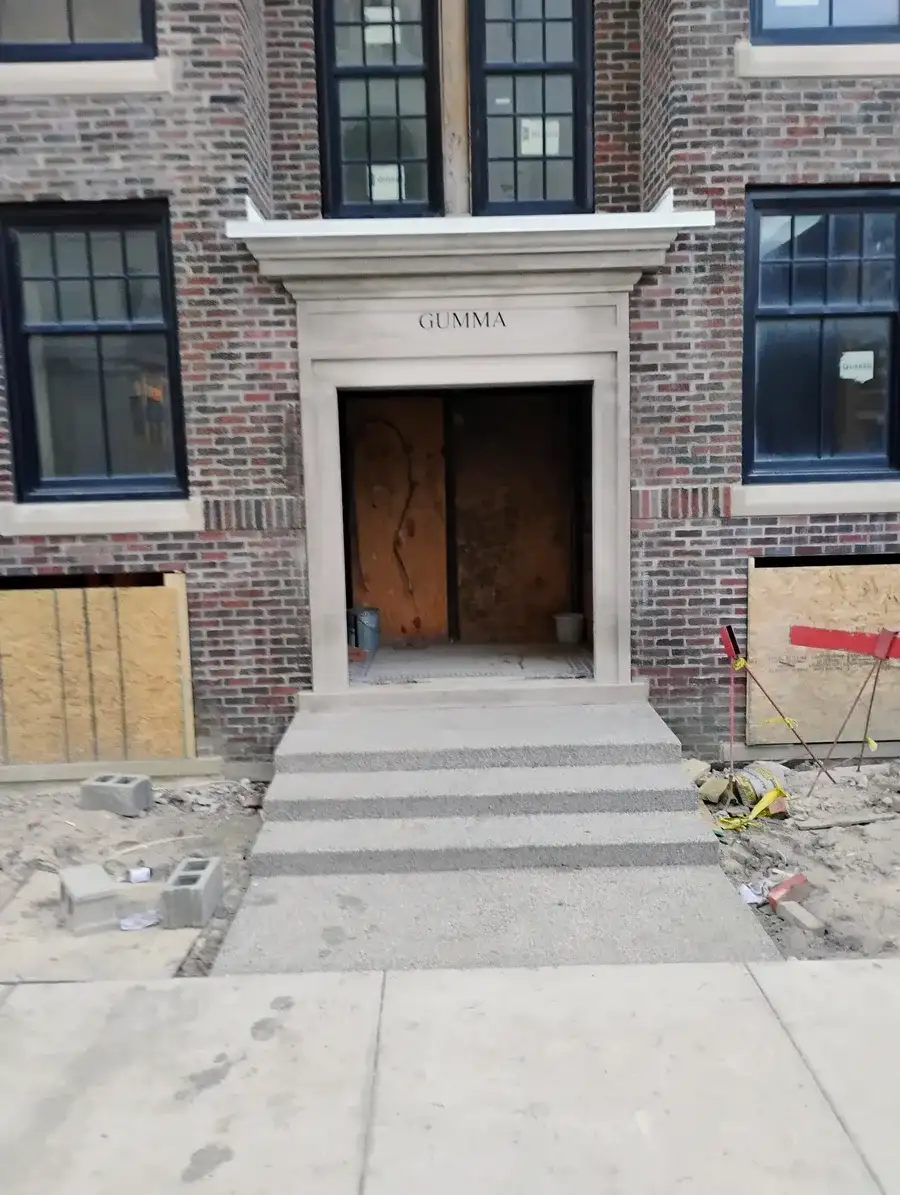 Brick storefront building showing completed roofing and waterproofing work on commercial canopy