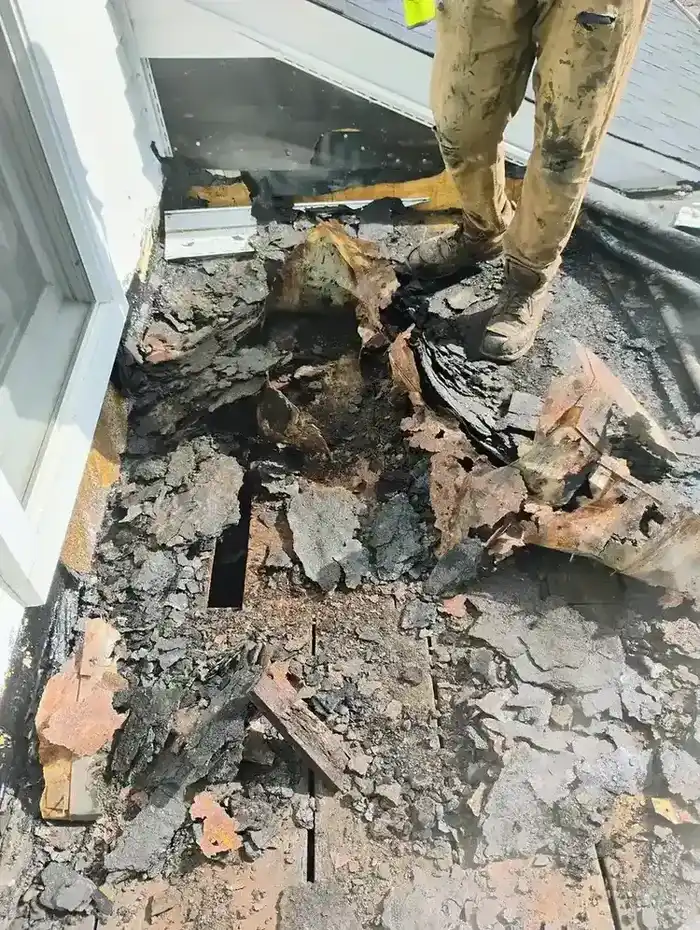 Severely deteriorated flat roof with rotted decking exposed during full tear-off and rebuild, Metro Detroit